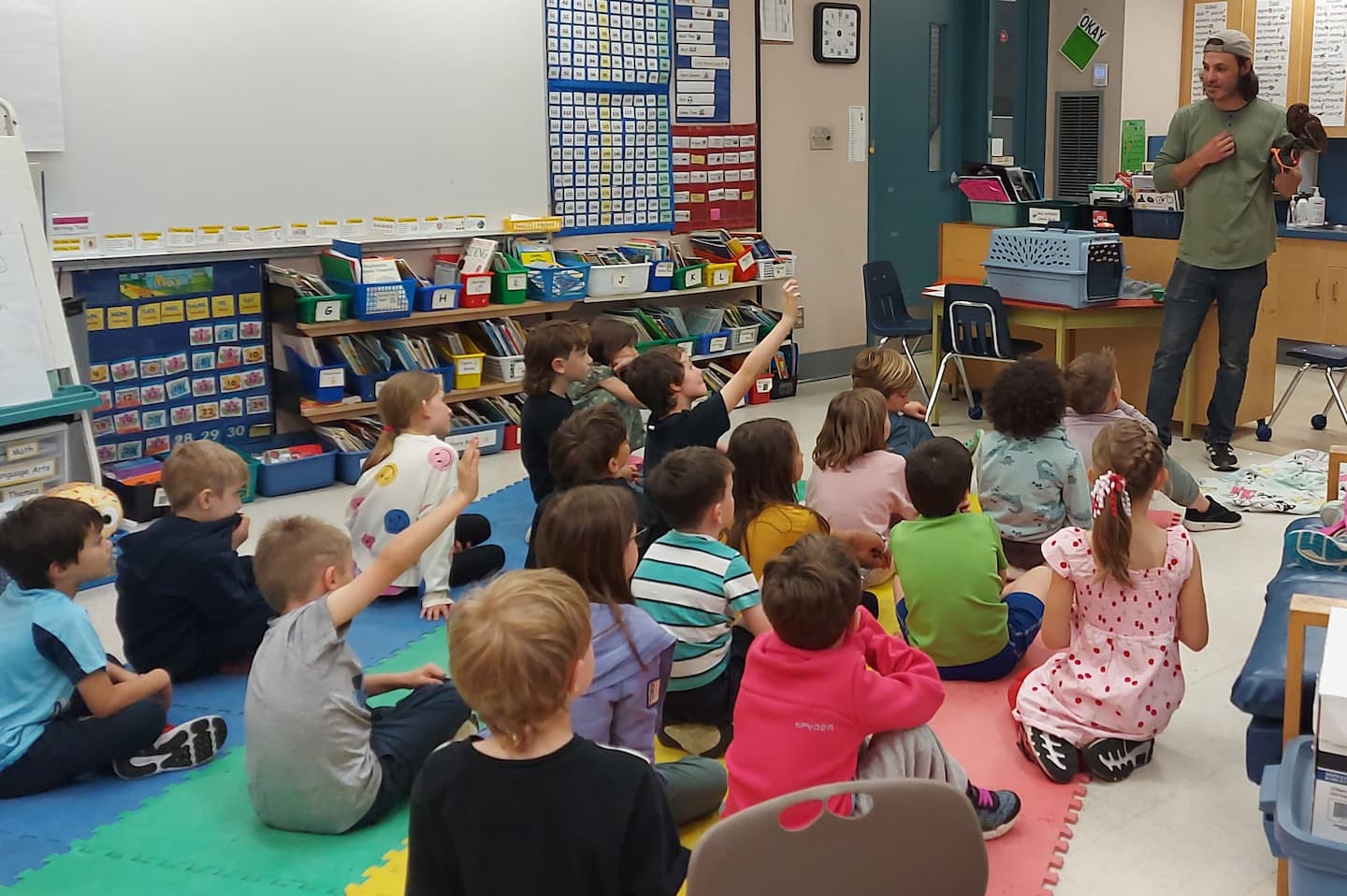 Aaron Schmidt visiting a classroom with an ambassador bird