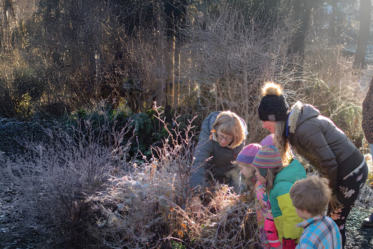 a group of young students learning about native plants
